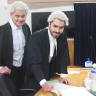 Lawyer Malcolm McKenzie swears in his son, William, as a barrister and solicitor in the High...