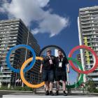 New Zealand weightlifter Laurel Hubbard and coach Callan Helms stand in front of the Olympic...