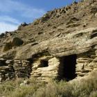 The ell-preserved remains of a goldminer's hut built of schist rock in one of the historic gold...
