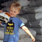 Charlie Hughes (5)  lifts a sack of sheep pellets at Wal’s Plant Land, in Mosgiel, yesterday...