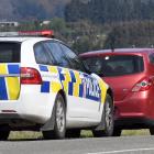Senior Constable Brent Christie tickets a speeding driver on State Highway 1 near Waitati.PHOTO:...