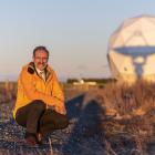 Robin McNeill stands in front of one the 35 antennas at Space Operations New Zealand’s Awarua...