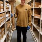 Otago Museum Natural Sciences assistant curator Kane Fleury holds a bone of a female South Island...
