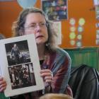 Poet Jenny Powell shows Tainui School pupils photographs of her first day at the school as a...
