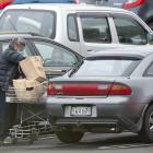  A supermarket shopper loads groceries into her car at Countdown Dunedin Central yesterday...
