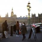 A person with face mask walks over Westminster Bridge in London. Photo: Reuters