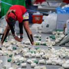 A runner stretches near discarded cups during the New York City Marathon. PHOTO: REUTERS