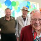 Connie Nelson proudly shows off her card from the Queen at her birthday party with three of her...