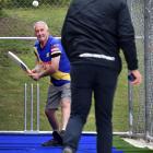 New Zealand cricket great Warren Lees gets on the front foot for a delivery from his son, Greg...