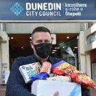 Support you can taste ... Dunedin City Council senior contract supervisor Terry Taylor holds  one...