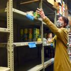 Presbyterian Support’s Julie Edmunds checks out the increasingly empty shelves at the...