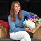 Collecting cans ... Steph Cardno-Fa’asega holds  a collection of food and other necessities...