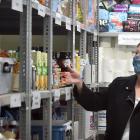 Checking out the bolstered Salvation Army foodbank shelves yesterday are (from left) Dunedin Host...