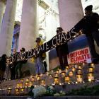 Environmental activists hold a banner as they attend a vigil near the Bank of England in London ...