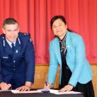 Police Commissioner Andrew Coster and Te Runanga o Ngai Tahu chief executive Arihia Bennet sign a...
