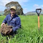 Westridge Farm owner Mark Anderson inspects soil on his dairy farm in South Otago last week....