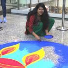 Rangoli artist Madhuri Kumari uses coloured powder to create a temporary pattern on the floor...