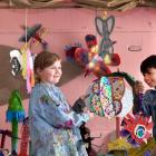 Showing off their colourful creations for the Port Chalmers Portable Art Parade are Honor Van Rij...