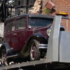 A 1930 Dodge is salvaged from the wreckage of the former Wolfenden and Russell building yesterday...