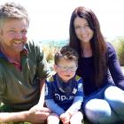The Wells family, Andy, Emilee, and son Harri (3) enjoy the sun at their Clinton farm yesterday....