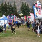The first of the thousands of Wanaka A&amp;P Show goers wander down one of the trade lanes after...