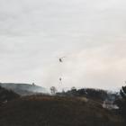 Helicopters help battle the out-of-control burn-off at Peebles this afternoon. PHOTO: REBECCA RYAN