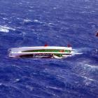 A Helicopters Otago aircraft approaches upturned trimaran Groupama 3 about 145km off the Otago...