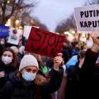 Demonstrators hold placards during an anti-war protest in front of the Russian embassy in Berlin,...