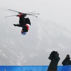 New Zealand’s Nico Porteous gets inverted during his second run in the men’s freeski halfpipe...