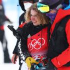 Ben Harrington reacts after crashing while being assisted by medical staff on their second run...