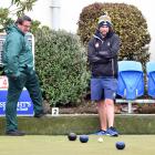 Oliver Mason (front) and rival skip Regan Larkin watch as the bowls roll in during the Dunedin...