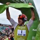 Dougal Allan raises the finishing ribbon in triumphat the finish of the Longest Day last year....