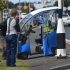 A man in an electric mobility scooter is attended at the scene by witnesses last weekend. PHOTO:...