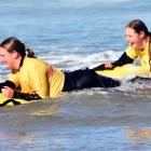 Performing training drills at Brighton Beach yesterday are Brighton Surf Life Saving Club members...