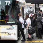 School pupils and other commuters squeeze on to the new Mosgiel bus service at the Great King St...