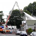 Emergency services use a bucket lift to drench exposed phosphorus found in Rutherford St in...
