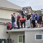 Students gather this week on the roof of a property in Castle St North. Fuelled by the...