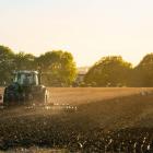 Tractor ploughing a field on a farm in the sunshine. Photo: Getty Images