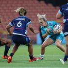 Liv McGoverne, of Matatu, looks for a gap in the Blues defence of (from left) Paticia Maliepo,...