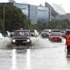 Cars attempt to negotiate flooding in Albany, Auckland after torrential rain  this week. PHOTO: NZME