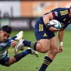 Highlander Freedom Vahakolo gets past the Blues’ Rieko Ioane during the 2022 Super Rugby Pacific...