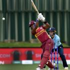 West Indies Batsman Hayley Matthews hits the ball while watched by England wicketkeeper Amy Jones...