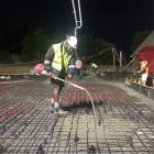 Anderson Construction contractor Filimoni Tagicakibau pours concrete over the mauri stone at the...