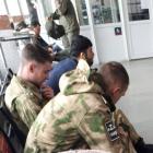 Young Russian conscripts at Belgorod train station near the Ukraine border this week, wearing...