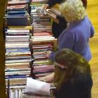 Tables heaving with books were being constantly restocked by the sale’s tireless volunteers while...