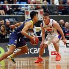 Otago Nuggets guard Nikau McCullough looks to drive as Nelson Giants guard Alex McNaught guards...
