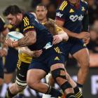 Highlanders prop Jermaine Ainsley carries the ball as replacement centre Fetuli Paea watches...