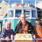 On board the MSV Monarch with a cake to celebrate its 70th anniversary are (from left) manager...