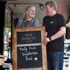 Potpourri Vegetarian Cafe’s former owners, Hilary and Craig Procter, hold its welcome sign. PHOTO...