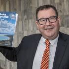 Finance Minister Grant Robertson with a copy of his Wellbeing Budget 2022 at Parliament,...